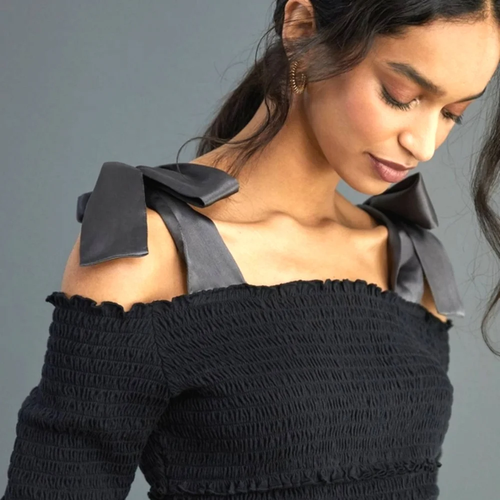 Anthropologie bow off shoulder smocked top black